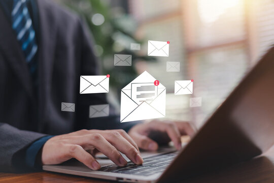 Business professional typing on a laptop with digital email icons illustrating online communication inbox notifications messaging workflow and modern office productivity for corporate digital content.