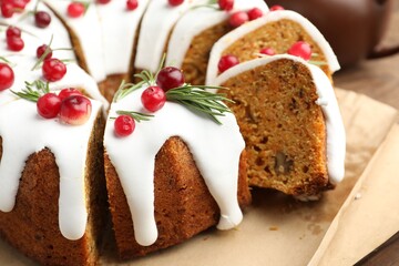 Tasty Christmas cake with cranberries on wooden table, closeup