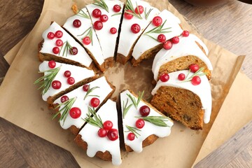 Tasty Christmas cake with cranberries on wooden table, top view