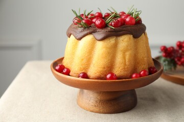 Tasty Christmas cake with cranberries on table, closeup