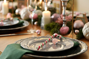 Festive table setting with Christmas decor at home, closeup