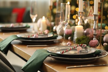 Festive table setting with Christmas decor at home, closeup