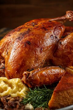 Close-Up of Traditional Thanksgiving Turkey and Side Dishes on Rustic Table	