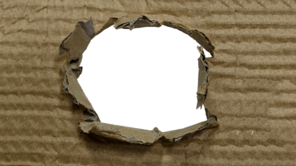 Close-up sheet of brown corrugated cardboard with roughly circular, irregular hole or tear center. Copy space for text or design elements. isolated on transparent background