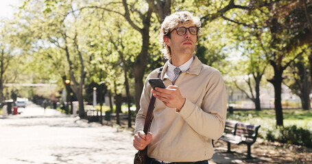 Phone, search and business man in park for communication, social media and navigation. Commute, networking app and connection with person and mobile outdoor for professional, trip route and travel © AzeemudDeen25/peopleimages.com