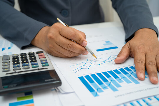 Asian business woman working with financial graph.