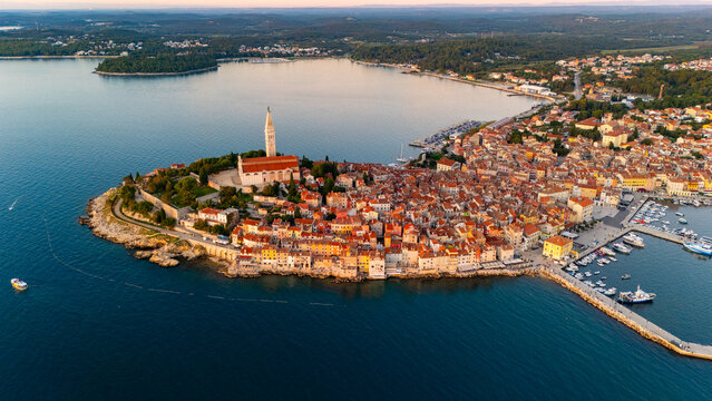 Fototapeta Rovinj Old Town at Sunset, Istria, Croatia – Scenic View of Red Rooftops, Adriatic Sea and Charming Mediterranean Streets in Golden Evening Light. Aerial View
