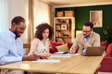 Insurance Agent Meeting With Couple At Home Office Table For Policy Discussion