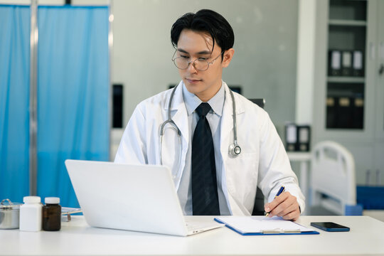 male medicine doctor hand holding silver pen writing something on clipboard close up. Ward round, patient visit check, medical calculation and statistics concept.
