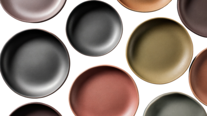 Various round plates with matte surfaces on a black backdrop