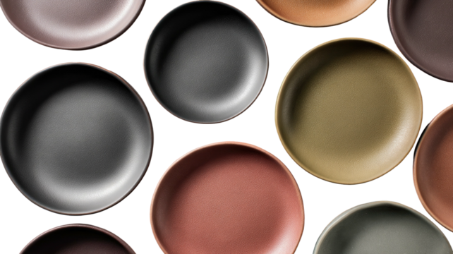 Various round plates with matte surfaces on a black backdrop