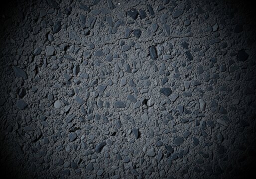 Close-up of dark asphalt road surface with small stones and cracks - Powered by Adobe