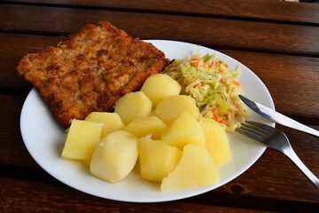 Pork chop with salad and potatoes