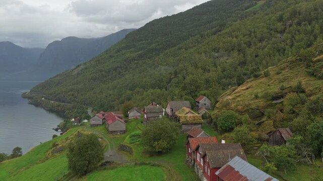 Traditional Norwegian fjord village Otternes captured from above on a misty day