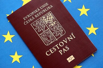 Czech biometrical passport on European Union flag background. Concept of citizenship of Czech Republic