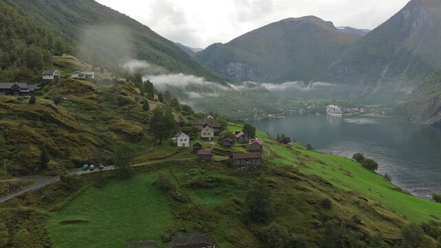 Moody weather over Otternes bygdetun heritage village beside fjord, seen from the air