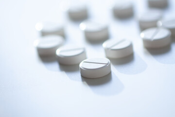 Vitamins and supplements on light backdrop. Conveys purity, health, and energy.