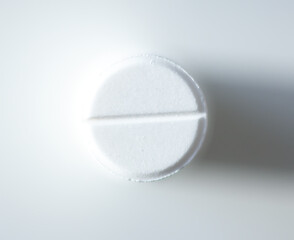 Various pills stacked on white background. Expresses clarity, vitality, and self-care.