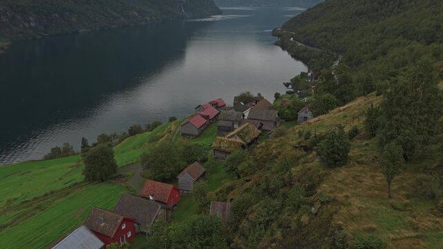 Aerial shot of Otternes heritage village by moody fjord in scenic Norway