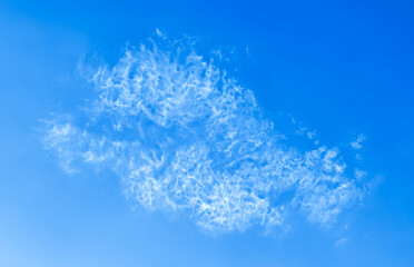 Cloud long wide form in the Blue Sky on Sunny Day. A translucent, dissolving sheet of lace, vapor from a cloud, floating into the distance. Nature Scenery with a Good Weather. Banner panoramic Screen.