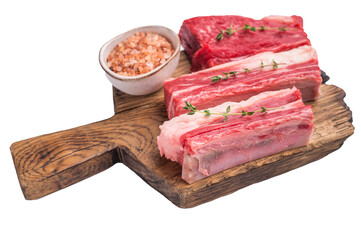 Three premium raw beef short ribs on a wooden cutting board with Himalayan pink salt and fresh thyme sprigs.