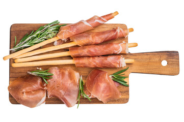 Italian Prosciutto Crudo and Grissini (breadsticks) on a wooden board, garnished with fresh...