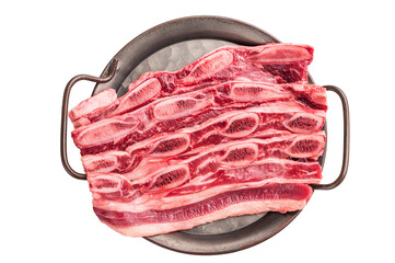 Uncooked cross-cut beef ribs arranged in a dark metal tray, emphasizing a gourmet or home cooking...