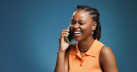 Phone call, laugh and black woman in studio for communication, joke and chat on blue background. Tech, conversation and African person with contact for news, gossip and comedy story with mockup space