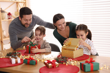Happy family with Christmas gifts at home