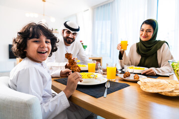 Emirati arab family enjoying meal together at home