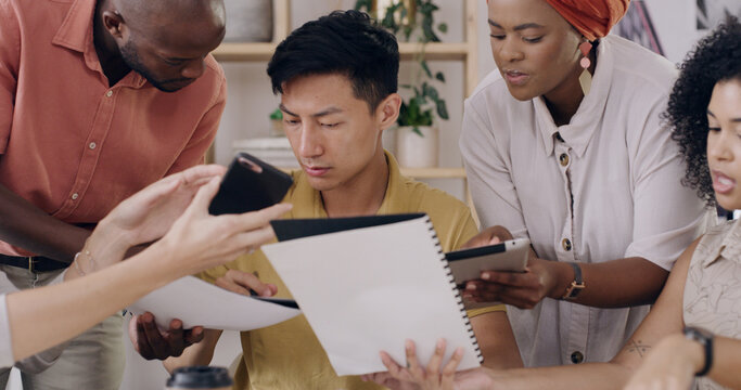 Man, chaos and overwhelmed with multitasking at startup with team, phone and documents at media company. Person, group and crisis management with deadline, overtime and review at creative agency