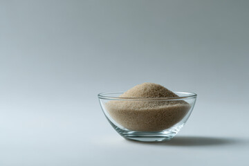 minimalistic composition featuring crystalclear glass bowl filled with grains on clean white background