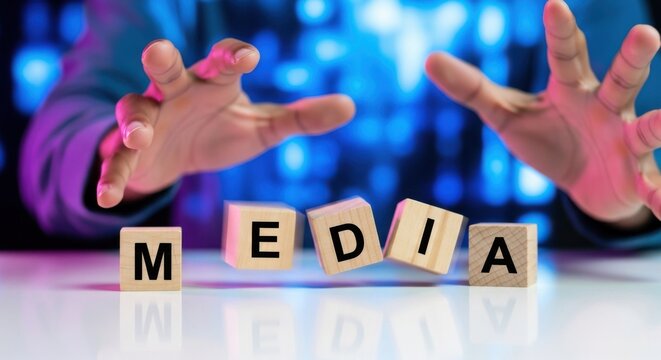 Wooden blocks spelling media hands in a gesture of control concept for news and communication