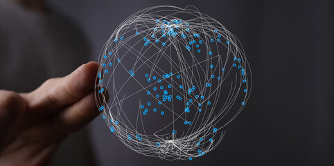 Concept image of a hand holding a digital globe, symbolizing the interconnectedness of global...