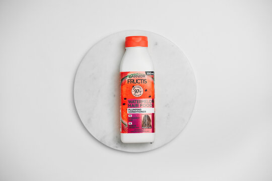 Strasbourg, France - November 2025 : Garnier fructis watermelon hair food conditioner bestseller, minimalist product editorial top view photo flat lay on marble podium