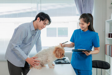 Happy dog with vet during regular health check, showing trust, care, and professional veterinary...