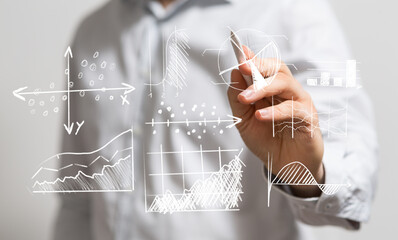 Business person analyzing and drawing data graphs. Concept of business intelligence, market analysis, or financial planning.