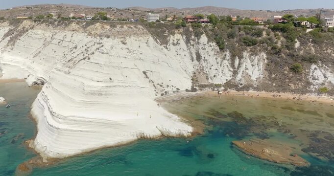 Aerial view of the Scala dei Turchi (Stair of the Turks or Turkish Steps) on the coast of Realmonte, near Agrigento, Sicily, Italy. It's a rocky cliff and tourist attraction. The sea is turquoise.