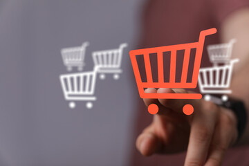 Hand pressing on a digital shopping cart. Represents online shopping, e-commerce, and digital retail. Perfect for illustrating online purchases