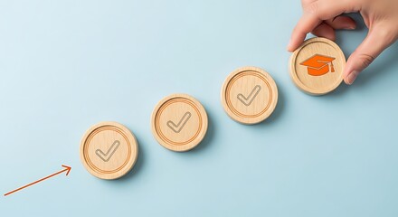 Wooden circles showing a checkmark and a hand holding a graduation cap