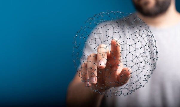 A close-up shot of a human hand interacting with a digital network sphere, representing global connection, innovation, and technological advance
