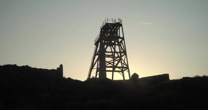 Old stone ruins of engine houses at Botallack mines on the Atlantic coast of Cornwall, England, UK during golden hour at sunrise