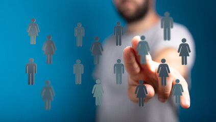 Hand pointing at male and female icons concept for team management, business connection, or social network conc