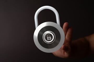 Close up shot of a hand holding a modern silver padlock with a lock icon. Represents data security...