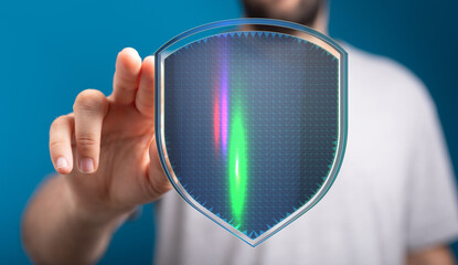 Hand touching digital shield with glowing lines, symbolizing cybersecurity, data protection, and...