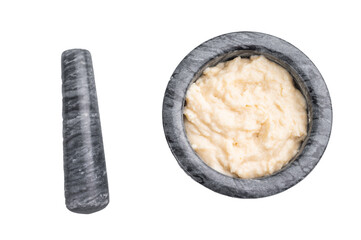 Freshly prepared cream sauce (horseradish or garlic aioli) being blended in a dark marble mortar and pestle. Homemade cooking process.