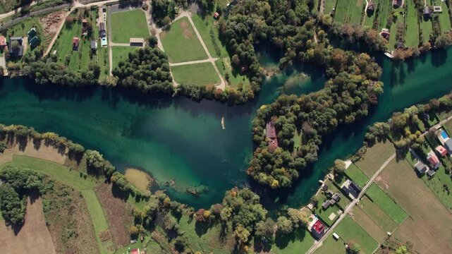 Drone footage of the Una River forming a natural heart shape near Bihac japodski otoci, Bosnia and Herzegovina. Clear turquoise water, lush forest, and surrounding countryside captured from above