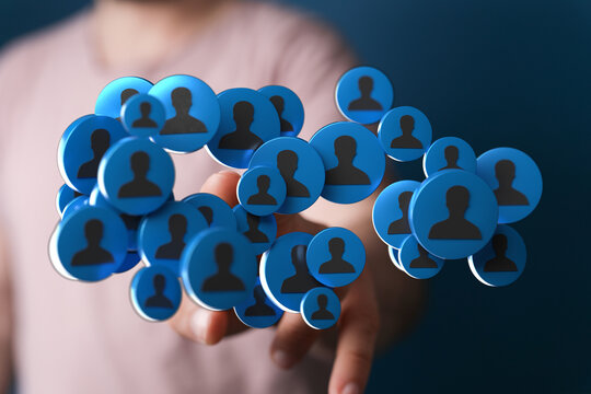 Close up shot of a hand holding a collection of blue person icon circles, symbolizing community, networking, and social media connections. Idea