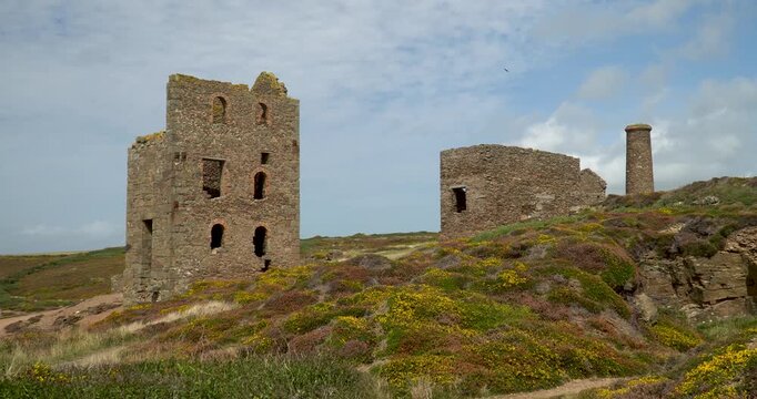 Old stone ruins of engine houses at Botallack mines on the Atlantic coast of Cornwall, England, UK during golden hour at sunrise