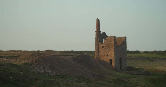 Old stone ruins of engine houses at Botallack mines on the Atlantic coast of Cornwall, England, UK during golden hour at sunrise